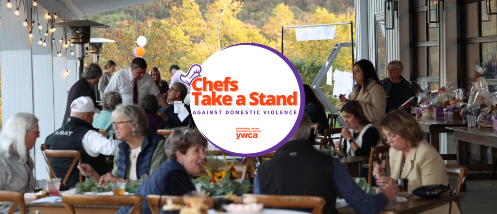 people eating and talking at tables outside