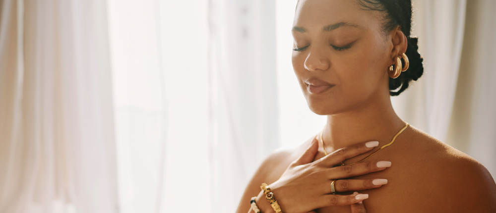 woman with eyes closed and hands on chest