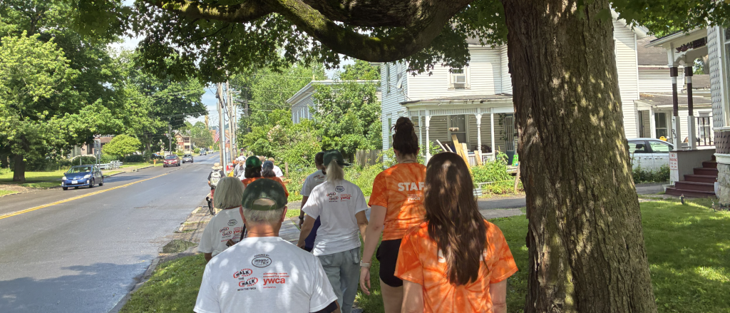 group of people walking on the sidewalk