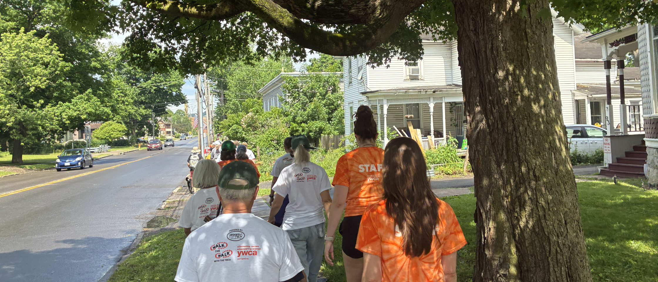 group of people walking on the sidewalk