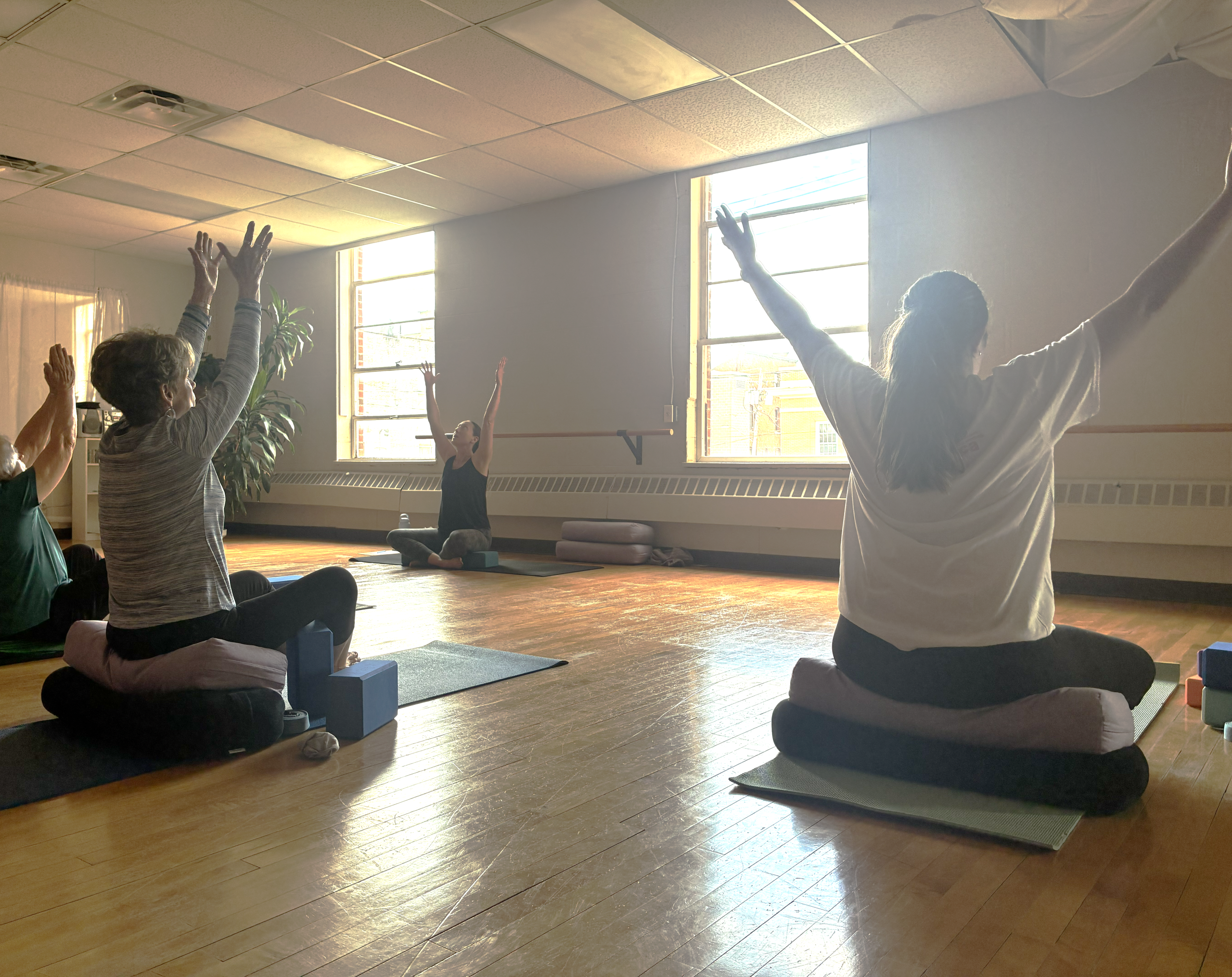 women sitting and stretching arms overhead