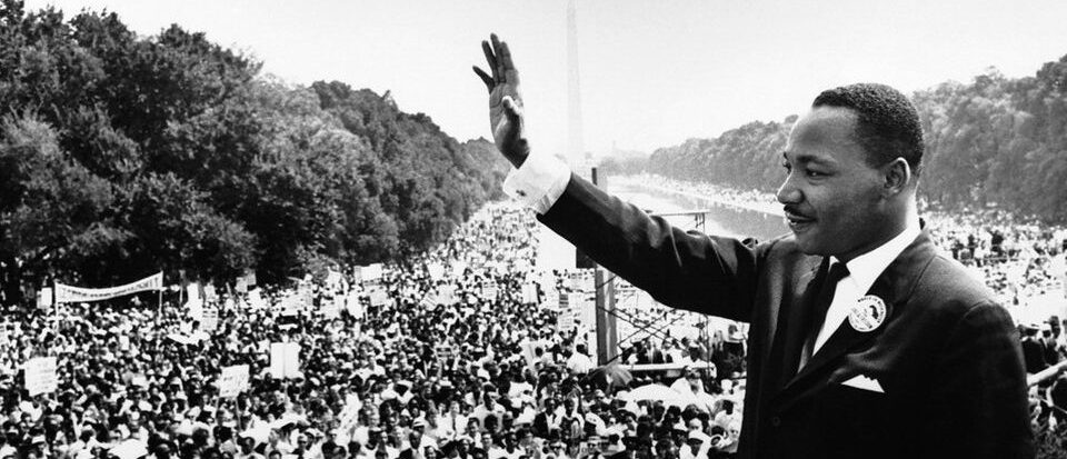Martin Luther King Jr. waving to a crowd
