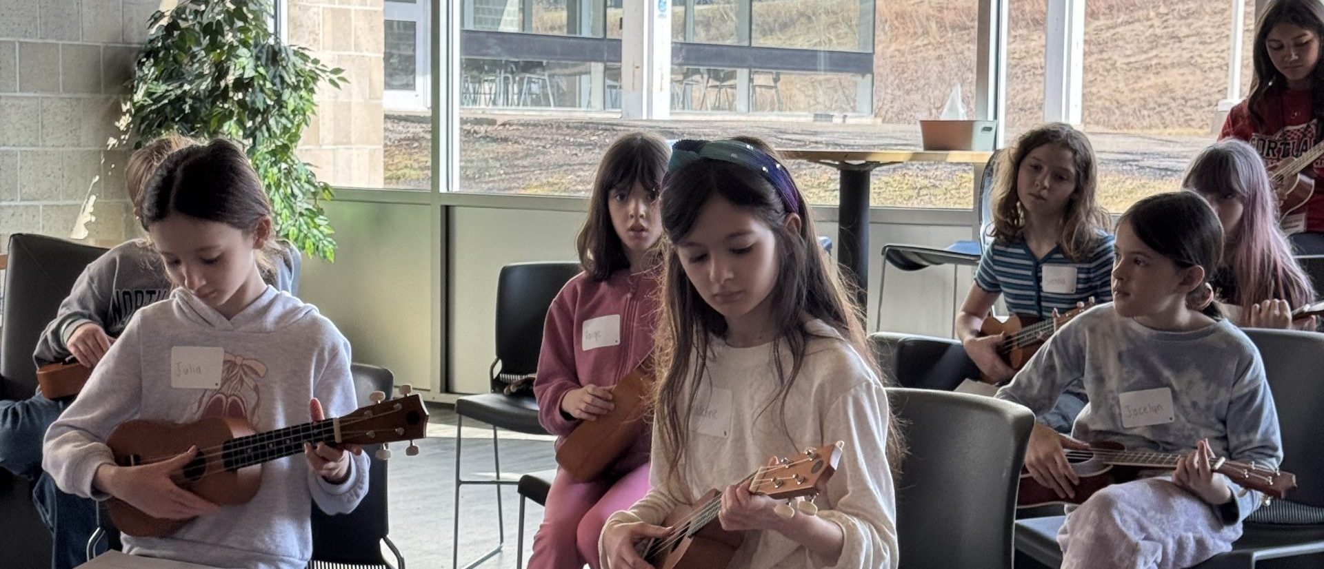 girls playing ukulele