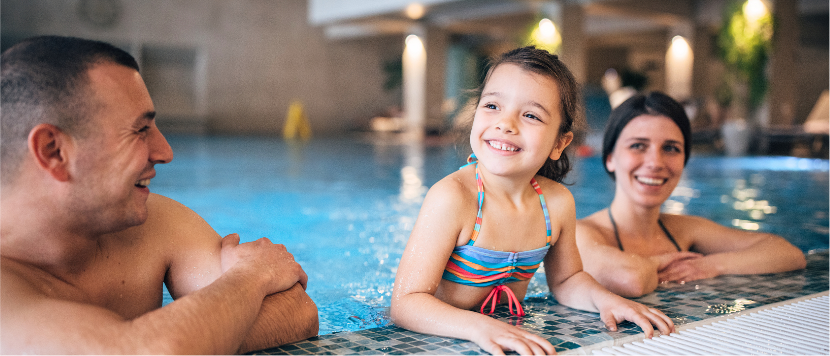 family in the pool together