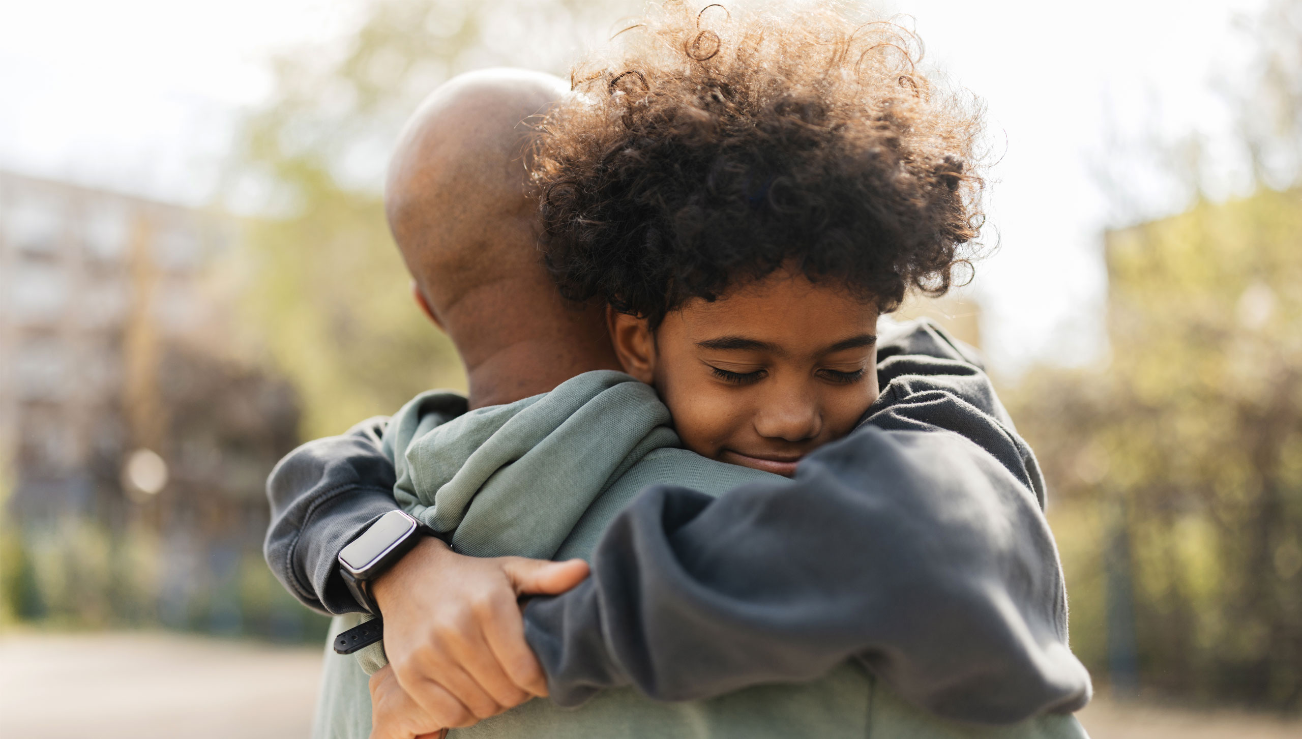 african american man and boy hugging mentoring ywca cortland
