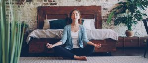 woman meditating on floor